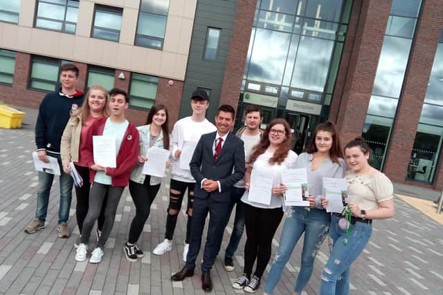Principal Brendon Fletcher with pupils celebrating their grades at New College Doncaster on its first ever A Level results day