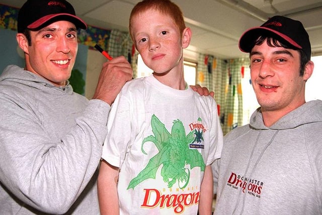 Dragon's players Darren Summerill and Lee Maher dropped into Doncaster Children's Hospital and presented Ward 28 with some t-shirts and an Easter egg. Our picture shows them with patient Robert Eardley, aged 11, April 1999