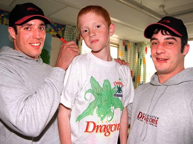 Dragon's players Darren Summerill and Lee Maher dropped into Doncaster Children's Hospital and presented Ward 28 with some t-shirts and an Easter egg. Our picture shows them with patient Robert Eardley, aged 11, April 1999