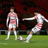 Doncaster's Ben Close fires in the second goal.
