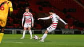 Doncaster's Ben Close fires in the second goal.