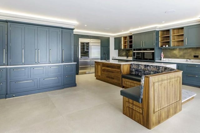 A hand-made kitchen includes Sub Zero and Miele appliances.