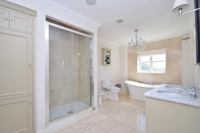 There are six bathrooms throughout the property, including three which are shared use and three private en-suites. This en-suite adjoins the main bedroom and features a double shower, roll top bath and his and hers sinks.