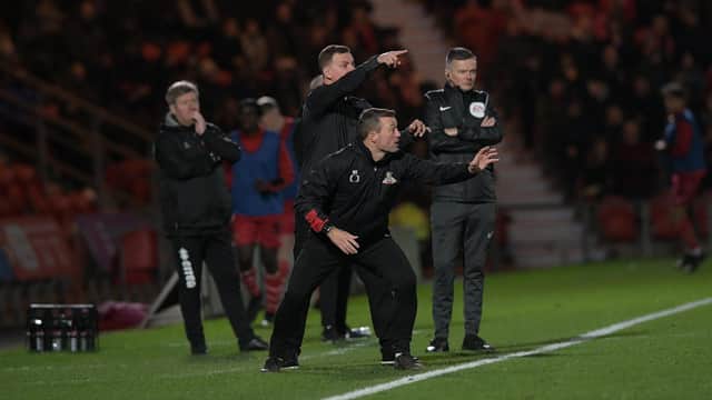 Richie Wellens and his assistant Noel Hunt give out instructions on the sidelines