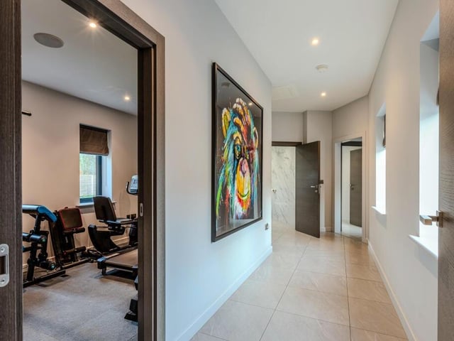 A home office is used currently as a home gym.