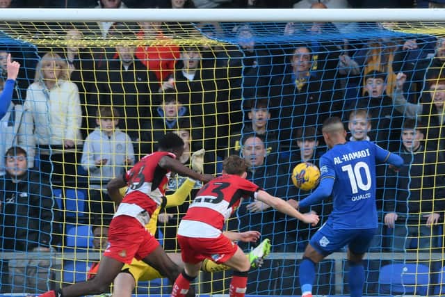 Ali Al Hamadi opens the scoring for AFC Wimbledon against Doncaster Rovers.