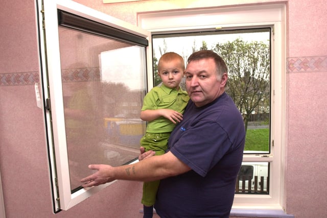 Ernest Baxby, 47, of Deerlands Mount, Sheffield, shows how the new window in the room of his 3 year old son, Ciaran, opens fully inwards.