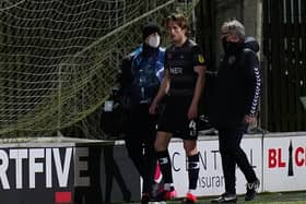 Tom Anderson is helped from the pitch after a head injury: Picture: Steve Flynn/AHPIX