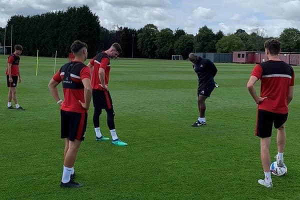 Darren Moore speaks to his players at Cantley Park