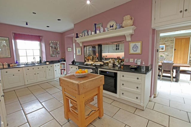 The kitchen is by Smallbone of Devizes and has a range of wall and base units with granite work surfaces.