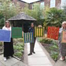 Artist Rubbena Aurangzeb-Tariq (centre) showcasing her artwork with  (L) Natalie Pollard, BSL manager at Doncaster Deaf Trust, and (R) Tracey Jamison, interim principal at Communication Specialist College Doncaster.