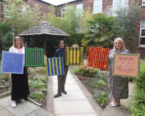Artist Rubbena Aurangzeb-Tariq (centre) showcasing her artwork with  (L) Natalie Pollard, BSL manager at Doncaster Deaf Trust, and (R) Tracey Jamison, interim principal at Communication Specialist College Doncaster.