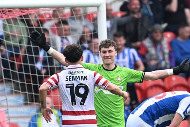 Doncaster's Louis Jones celebrates the win over Colchester with Charlie Seaman.