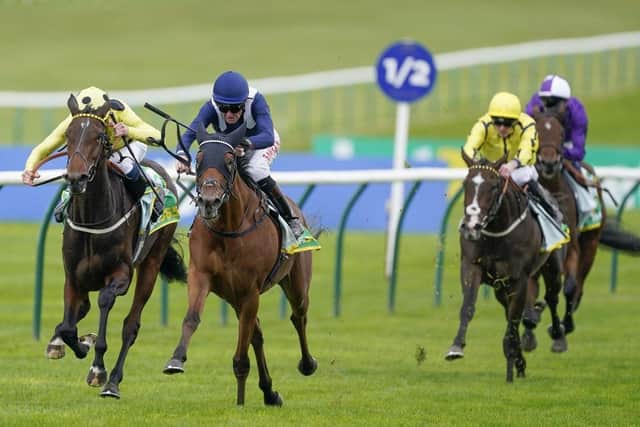 Robert Havlin rides Commissioning (blue) to victory in the bet365 Fillies' Mile at Newmarket on Friday. Photo: Alan Crowhurst/Getty Images