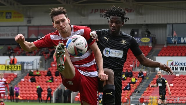 Joe Wright battles with Wigan goalscorer Viv Solomon-Otabor. Picture: Andrew Roe/AHPIX