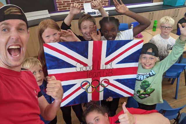 Children at summer camp cheering for Team GB.