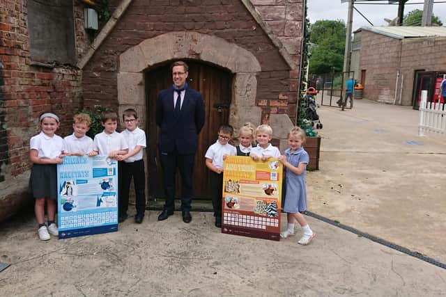 The pupils - Charlie, Archie, Billy, Ellie, Toby, Harry, Daisy and Tiana - with their information boards