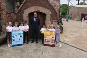 The pupils - Charlie, Archie, Billy, Ellie, Toby, Harry, Daisy and Tiana - with their information boards