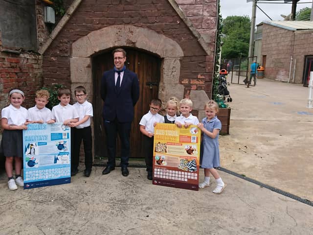 The pupils - Charlie, Archie, Billy, Ellie, Toby, Harry, Daisy and Tiana - with their information boards