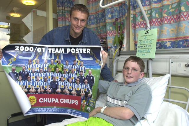 Pictured at  the Sheffield Childrensa Hospital, where Sheff Wednesday player Ian Hendon is seen preseting a team poster to fan Joseph Twelvetrees, 14, who had his legs broken in farm machinery.