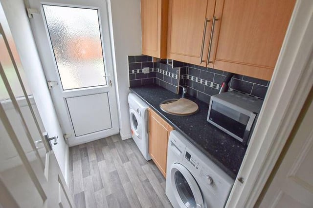 At one end of the kitchen sits this useful utility room, with more storage units and space for a washing machine and tumble dryer.