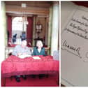 King Charles and Queen Consort Camilla sign the visitors' book at the Mansion House.