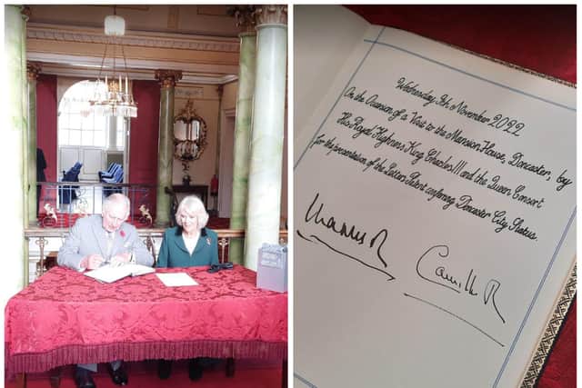 King Charles and Queen Consort Camilla sign the visitors' book at the Mansion House.