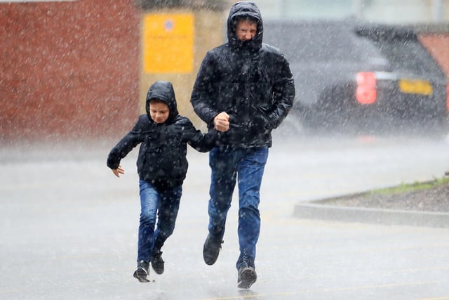 A dad and his lad look to escape the rain before United's game against Bournemouth at Bramall Lane