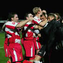 Jan Budtz is mobbed by his Rovers teammates after the shoot-out win over Manchester City in  2005. (Photo by Michael Steele/Getty Images)