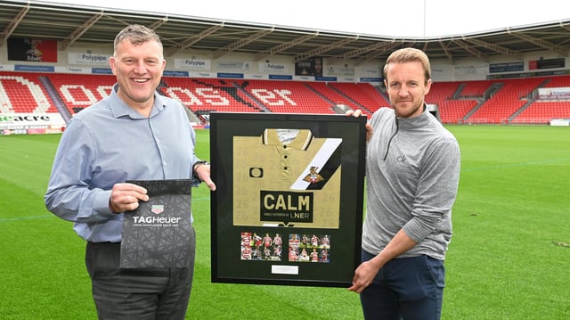 James Coppinger receives tokens of appreciation for his playing career from Doncaster Rovers CEO Gavin Baldwin