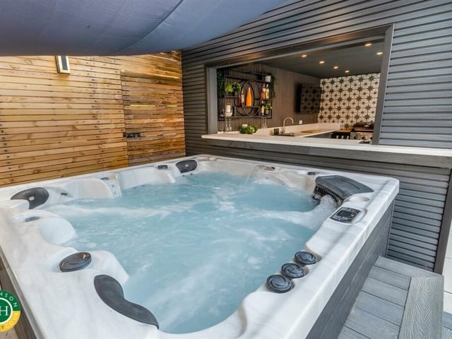 The hot tub area, adjacent to the outdoor kitchen.