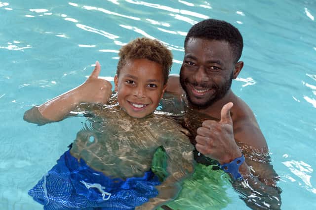 Haruna Adama, pictured with his son Lenny Adama, nine, at the swimming pool at the Dome.  Pools are to get money in Doncaster. Picture: NDFP-01-06-21-TheDome 8-NMSY