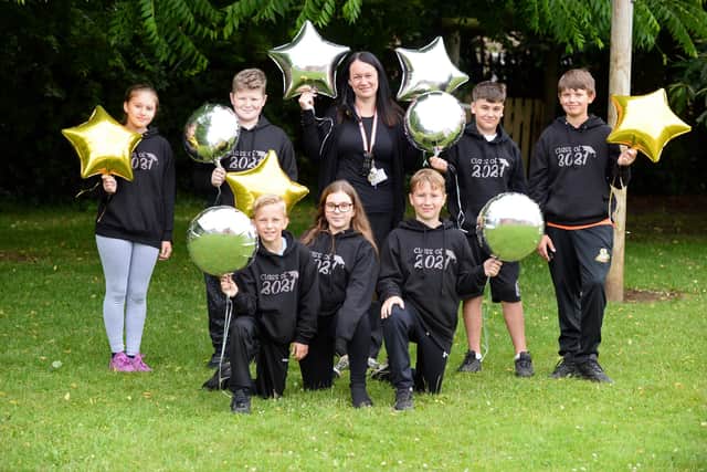 Kerry Frost, Fundraising Co-ordinator, pictured with year six pupils, Rihanna, Morgan, Danni, Rio, Joeboy, Bailey and Neil at Sheep Dip Lane Primary School. Picture: NDFP-13-07-21-FundraisingCelebrations 1-NMSY