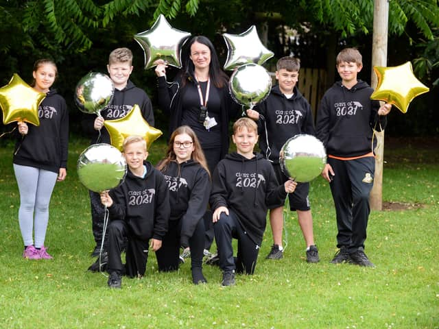 Kerry Frost, Fundraising Co-ordinator, pictured with year six pupils, Rihanna, Morgan, Danni, Rio, Joeboy, Bailey and Neil at Sheep Dip Lane Primary School. Picture: NDFP-13-07-21-FundraisingCelebrations 1-NMSY