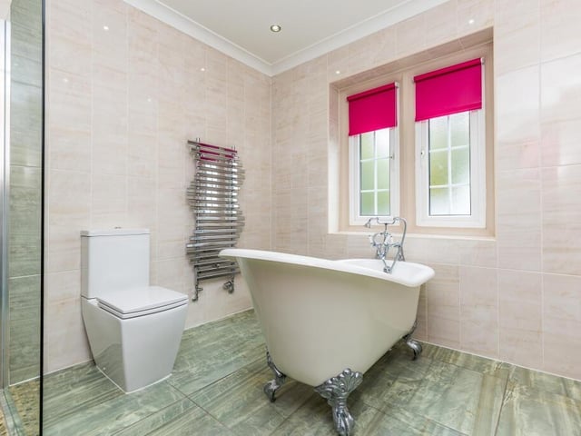 A free standing slipper bath features in this house bathroom.