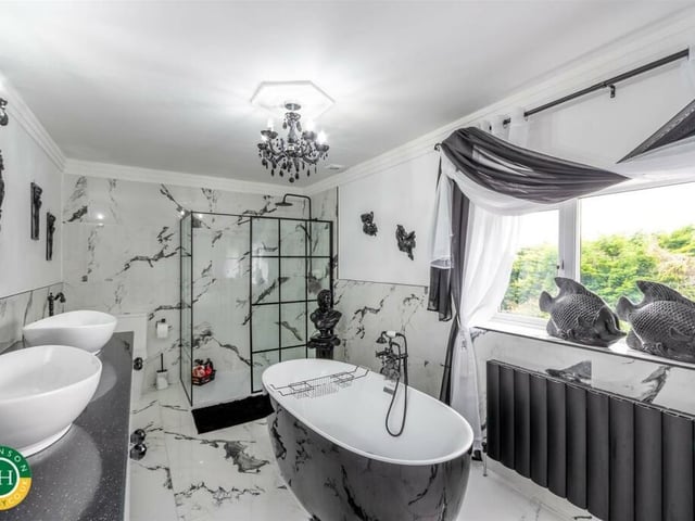 A luxury bathroom with freestanding bath and walk in shower.