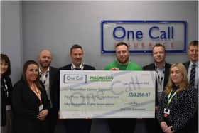 One Call Insurance staff hand over the cash to Macmillan.
