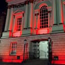 Doncaster's Mansion House lit up in red.