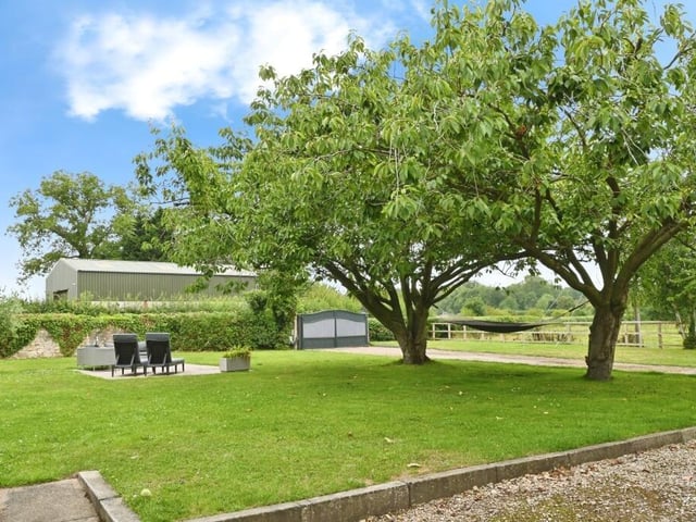 The property has extensive gardens and a paddock.