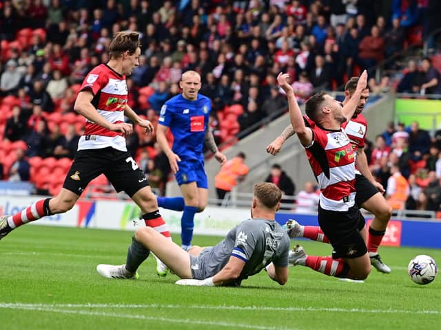 Tommy Rowe appeared to be brought down by Mark Oxley but the referee played advantage. Picture: Howard Roe/AHPIX LTD