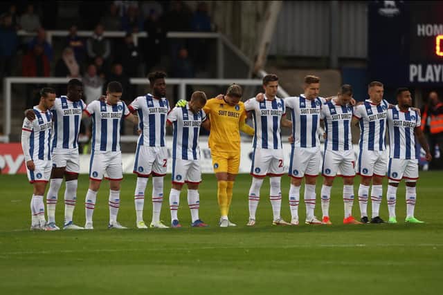 Hartlepool United's players observe a minute's silence as a mark of respect at Victoria Park earlier this season (photo: Mark Fletcher | MI News).