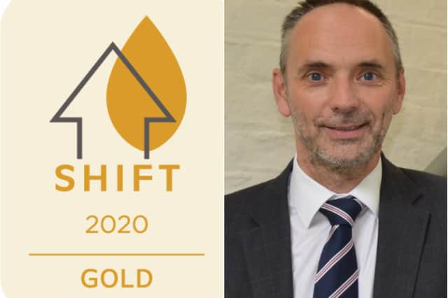 The SHIFT gold award and Dave Richmond. chief executive of St Leger Homes