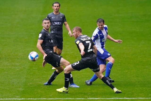 Ben Whiteman and Brad Halliday watch on as Wigan's Chris Merrie threads through a pass. Picture; Steve Flynn/AHPIX