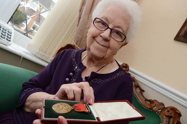 Doris May Kitching, of Barnby Dun, when she was aged 92, with the medal given in her fathers honour after the Bentley Pit Disaster.  Picture: Liz Mockler D4258LM