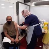 Abid Munaz is vaccinated by nurse and Kayle Nazimek at Belle Vue Mosque in Doncaster