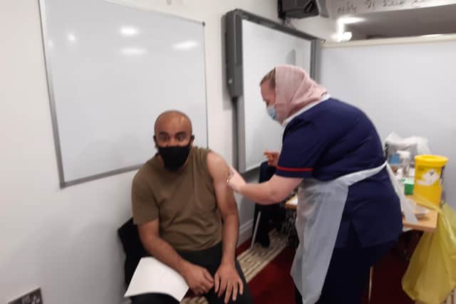 Abid Munaz is vaccinated by nurse and Kayle Nazimek at Belle Vue Mosque in Doncaster