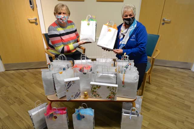 Jayne and Pauline handing over the packs at St John’s