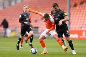 Doncaster Rovers player-manager Andy Butler battles with Blackpool's Jerry Yates.