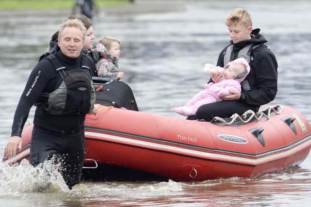Residents on Yarborough Terrace in Doncaster are rescued from their homes as flood waters rise in the area following heavy rain
