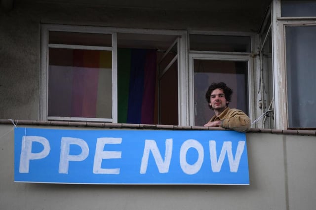 Residents in a Brighton seafront apartment block join in the Clap for Our Carers in support of the NHS on April 30 in Brighton (Photo: Mike Hewitt/Getty Images)